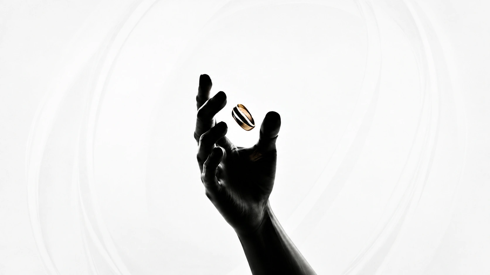 A hand reaching for the Orinex smart ring as it floats in mid-air
